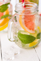 Homemade healthy smoothie with fresh fruits and ice in jar.