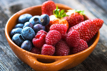 Delicious berries on a wooden background