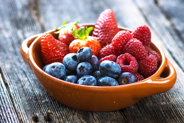 Delicious berries on a wooden background