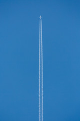 Aircraft in air with sky trails