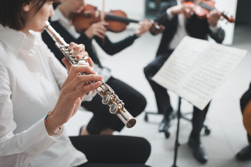 Fototapeta premium Flutist playing her instrument on stage