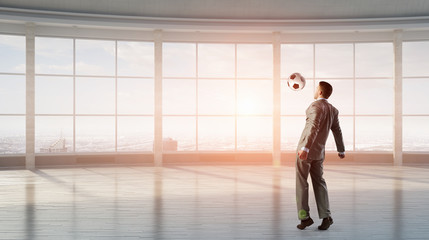 Fototapeta premium Playing football in office