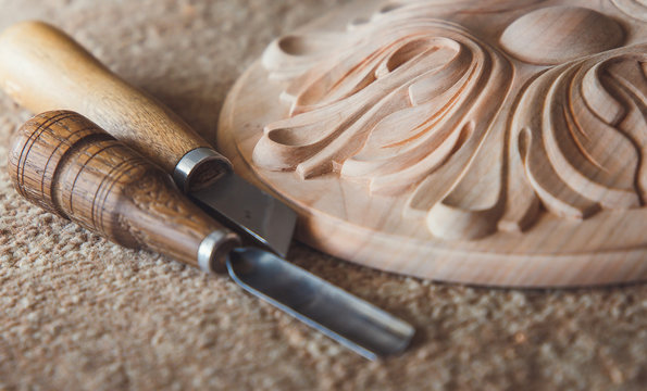 Timber, wood processing. Joinery work. wood carving with work tools close up. small depth of field. used as background