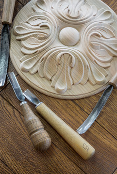 Wood. timber processing. Joinery work. wood carving. a wood carvings, tools on the wooden background close up. blurred. used as background