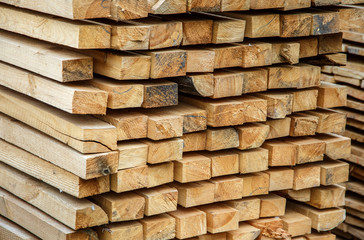 Wood timber construction material for background and texture. Wooden boards in a warehouse of building materials