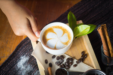 Creative work with a cup of boiling water in his hands. A handfu