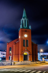 Fototapeta na wymiar St. Peter Church or St. Petri Kirke nicely lit at night time in