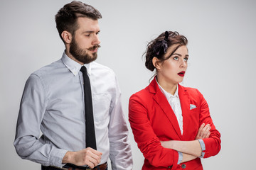 The business man and woman communicating on a gray background