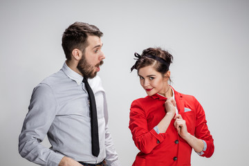 The business man and woman communicating on a gray background