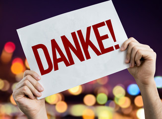 Thank You (in German) placard with night lights on background