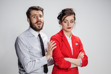 The business man and woman communicating on a gray background