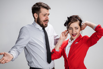 The business man and woman communicating on a gray background