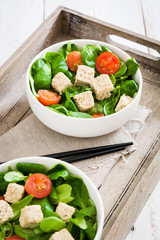 Vegan tofu salad with tomatoes and lamb's lettuce
on tray