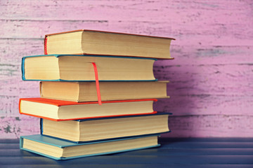 Pile of books on wooden background