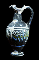 Ancient mosaic glass flask isolated on black