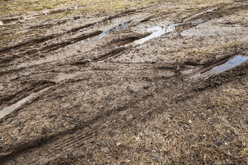 Dirty road with puddles and mud, countryside