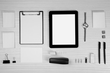 Office set with sheets of paper, tablet and stationery on light wooden background