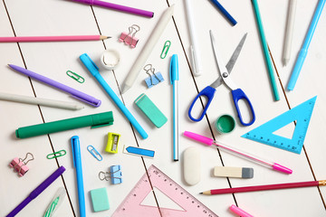 Flat lay of stationery on white wooden table background