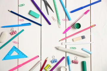 Flat lay of stationery on white wooden table background, copy space