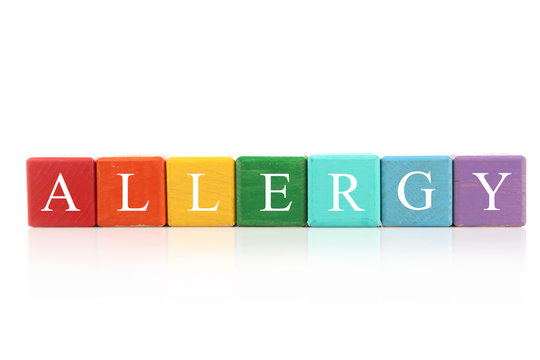 Allergy food concept. Wooden cubes on white background