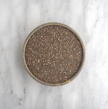 Chia Seeds In A Bowl On A Marble Cutting Board