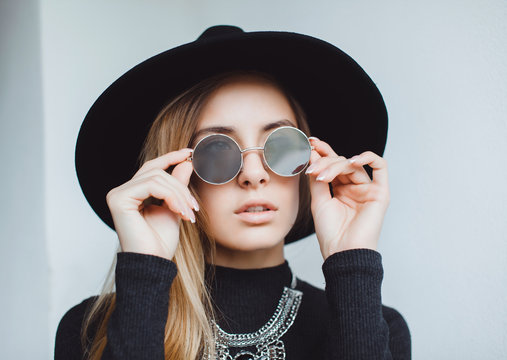 Hipster stunning woman making selfie , sending kiss, surprised funny emotions, natural make up, long blonde hairs, hipster hat and glasses, amity time, countryside. isolated
