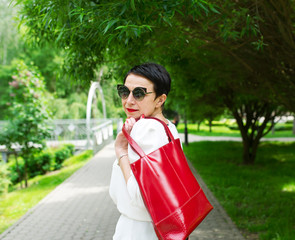 Brunette walks in the city park.