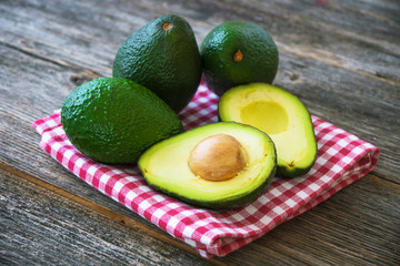 Avocado on wooden background © Daniel Vincek