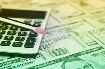 Fototapeta premium Pencil and calculator on dollar bank note money, Finance concept