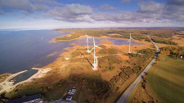 Aerial view of the island of Saarema and the windmills there is a long road beside the field where in the windmills are located