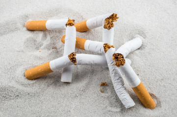 Quit Smoking - Broken unsmoked cigarettes in sand