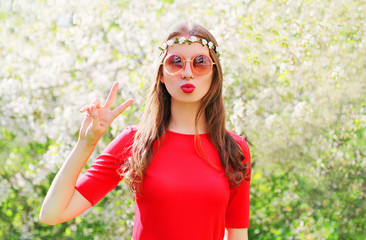 Fashion beautiful hippie woman having fun in flowering garden