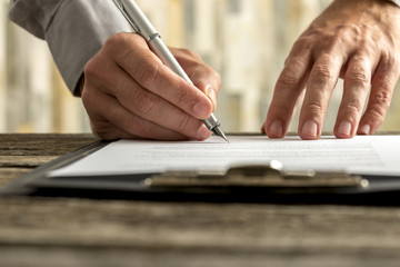 Male hands signing document, contract or application form