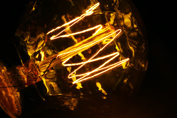 Illuminated light bulb on black background