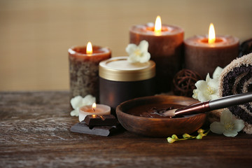Spa chocolate set with candles on brown background