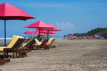 sunbeds and parasols on the beach.