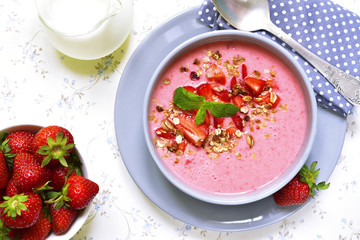 Strawberry oat smoothie in a gray bowl on a light background.