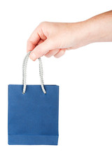 Hand holding little blue gift bag