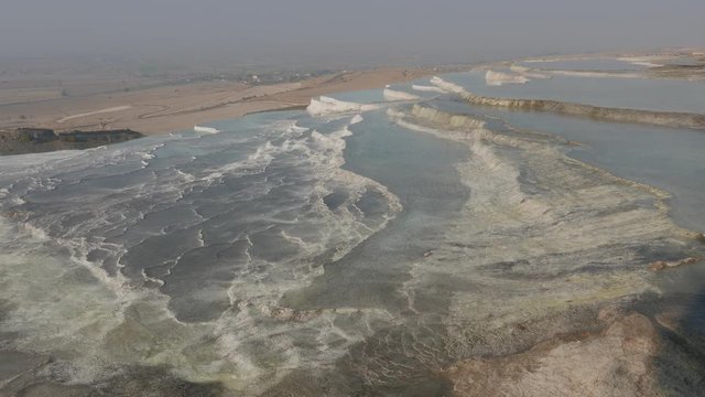 White travertines with a valley in a distance, Pamukkale, Turkey. 4k