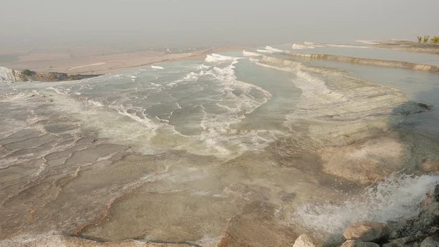 Travertines with hot mineral water and steam, Pamukkale, Turkey. 4k