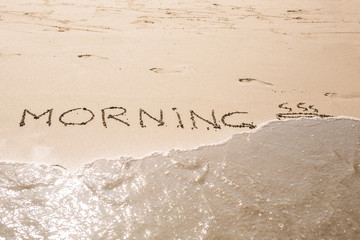 Abstract hand writing on the sand word Morning