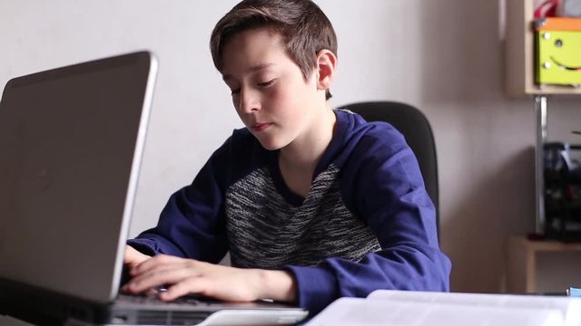 Boy Typing on The Laptop Keyboard