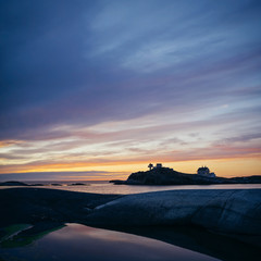 Fototapeta na wymiar Picturesque sunset near Stavanger, Norway. Lighthouse background.