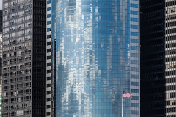 Obraz premium Skyscraper background with US flag in New York City