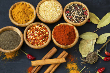 Spices powders and seeds with chili peppers and bay leaves