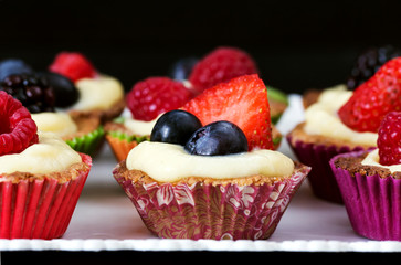 close up of mini pastry with custard cream and red fruits