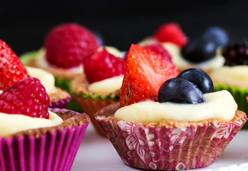 close up of mini pastry with custard cream and red fruits