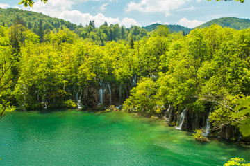 Beautiful landscape, waterfall and clear green water in the Plitvice Lakes National Park in Croatia, panoramic view