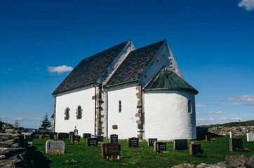 Fototapeta na wymiar Talgje Kirke - ancient medieval parish church built around year 1100 on Talgje island, Rogaland, Norway.