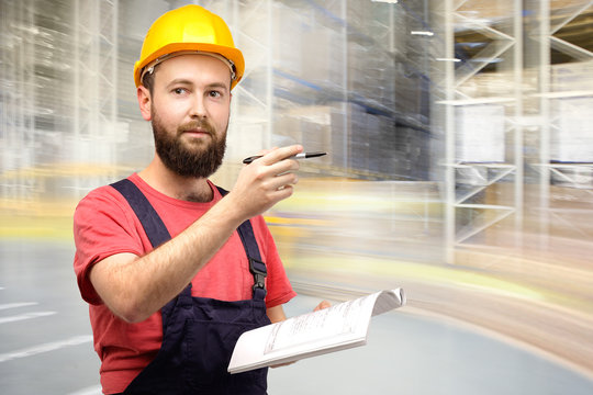 Warehouse worker in a yellow halmet